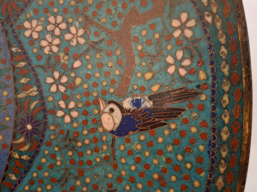 A circular Japanese cloisonne enamel charger decorated with geometric reserves, floral patterns, foliage, and bird motifs in blue, green, and terracotta tones. View VIII