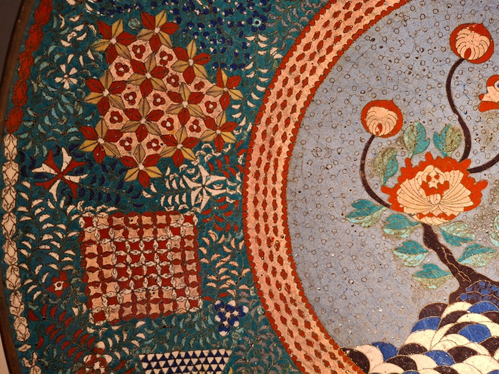 Large circular antique Japanese cloisonne enamel charger featuring a central peony motif surrounded by intricate geometric and floral diaper patterns in teal, blue, and coral hues. View V