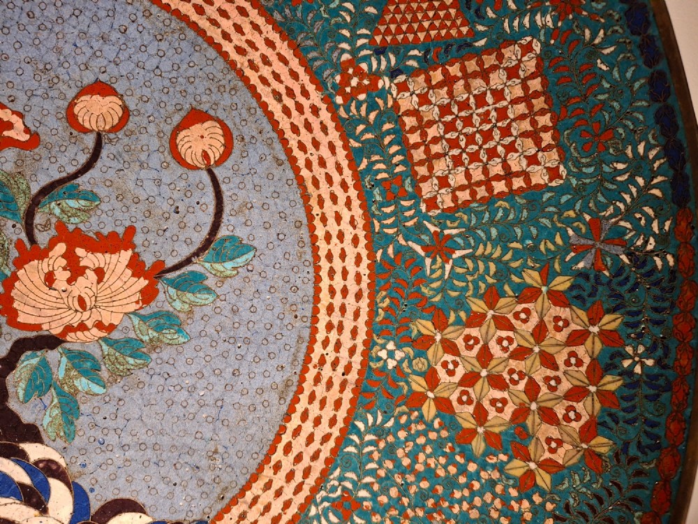Large circular antique Japanese cloisonne enamel charger featuring a central peony motif surrounded by intricate geometric and floral diaper patterns in teal, blue, and coral hues. View VI