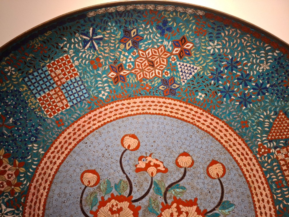 Large circular antique Japanese cloisonne enamel charger featuring a central peony motif surrounded by intricate geometric and floral diaper patterns in teal, blue, and coral hues. View VII