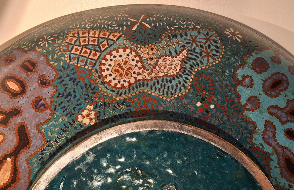 Large circular antique Japanese cloisonne enamel charger featuring a central peony motif surrounded by intricate geometric and floral diaper patterns in teal, blue, and coral hues. View XIII