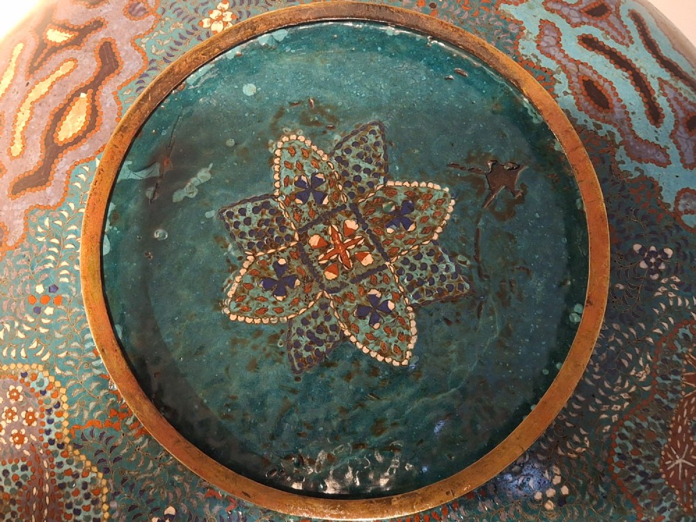 Large circular antique Japanese cloisonne enamel charger featuring a central peony motif surrounded by intricate geometric and floral diaper patterns in teal, blue, and coral hues. View XIV