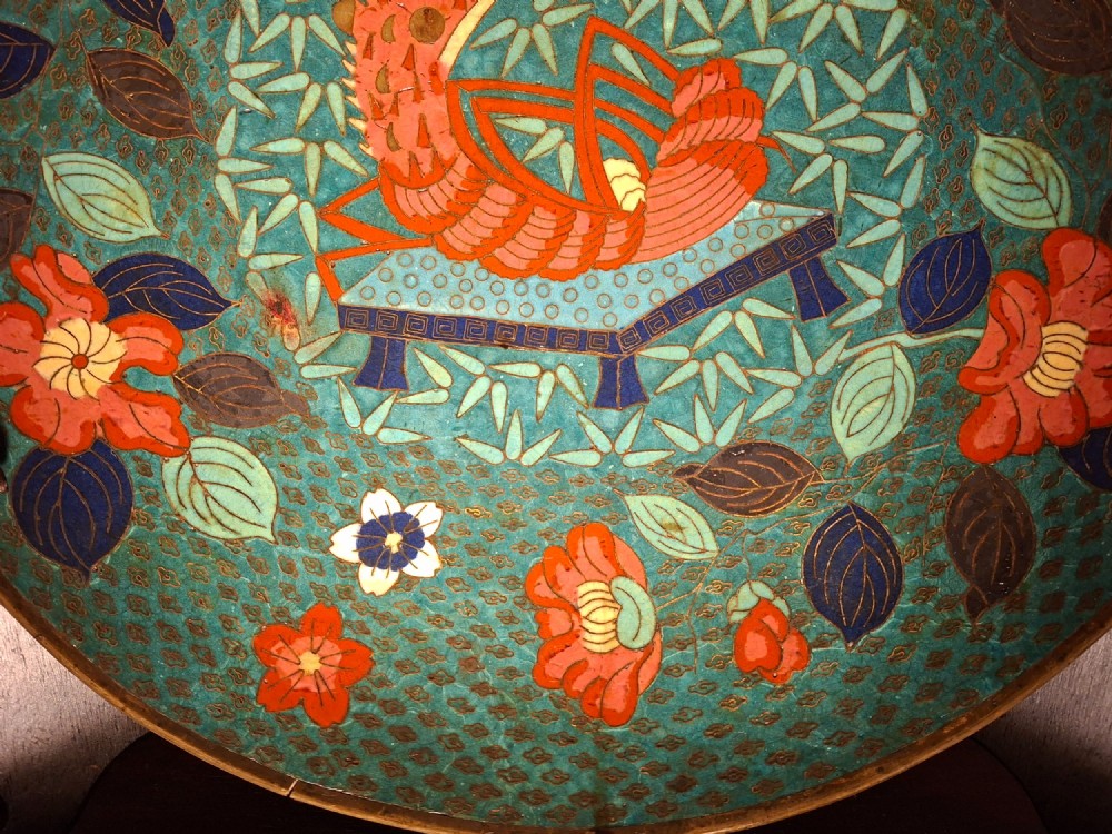 A circular Japanese cloisonne enamel charger displaying an orange shrimp motif surrounded by red flowers on a teal green pattern background. View VI
