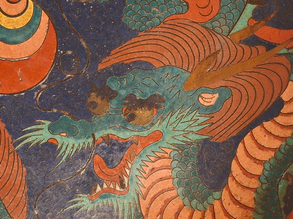 A circular Japanese Meiji period cloisonne enamel charger featuring a green and terracotta coiling dragon surrounding a flaming pearl on a dark blue background. View II