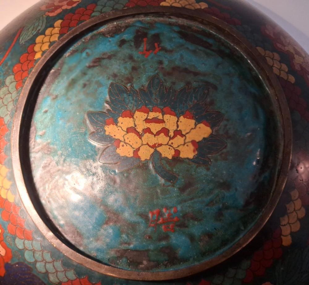 A circular Japanese Meiji period cloisonne enamel charger featuring a green and terracotta coiling dragon surrounding a flaming pearl on a dark blue background. View XIII