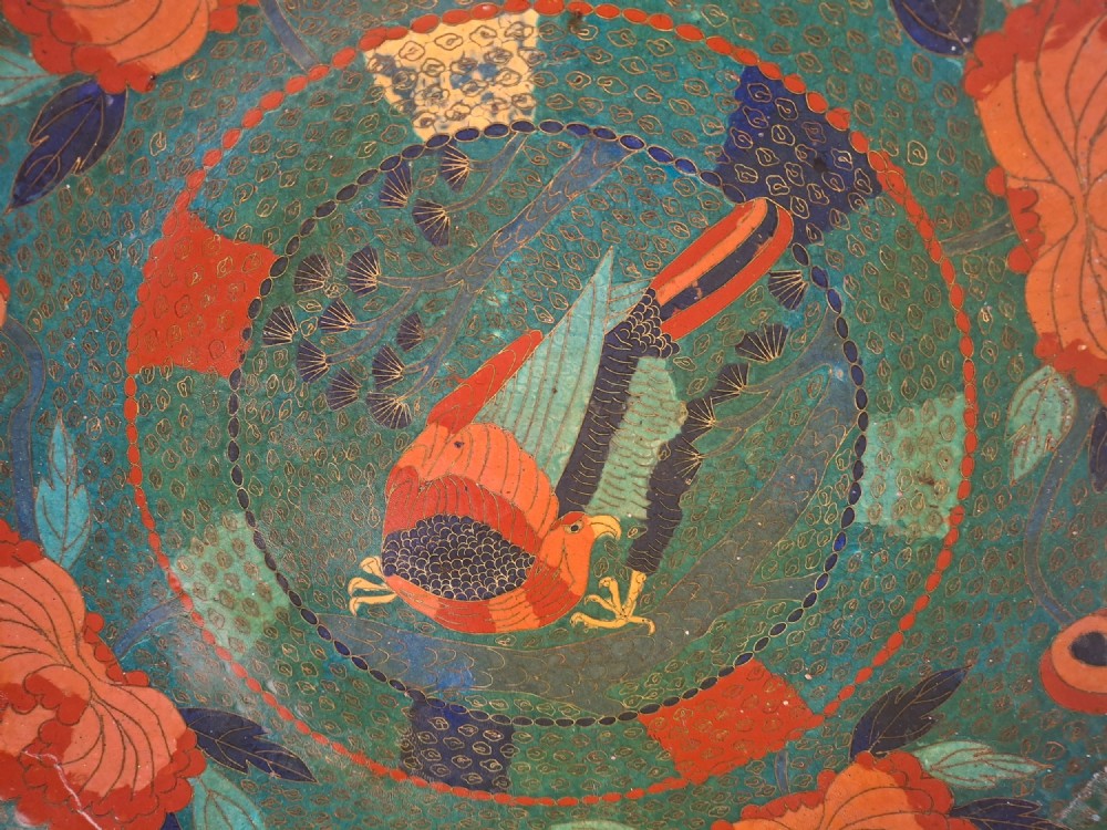 A circular antique Japanese cloisonne charger featuring a central bird motif surrounded by large orange peony blossoms on a green patterned enamel ground. View II