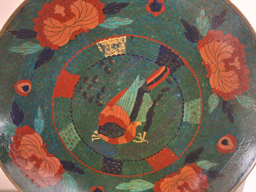 A circular antique Japanese cloisonne charger featuring a central bird motif surrounded by large orange peony blossoms on a green patterned enamel ground. View IV