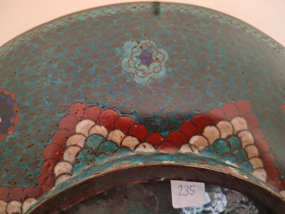 A circular antique Japanese cloisonne charger featuring a central bird motif surrounded by large orange peony blossoms on a green patterned enamel ground. View XIII