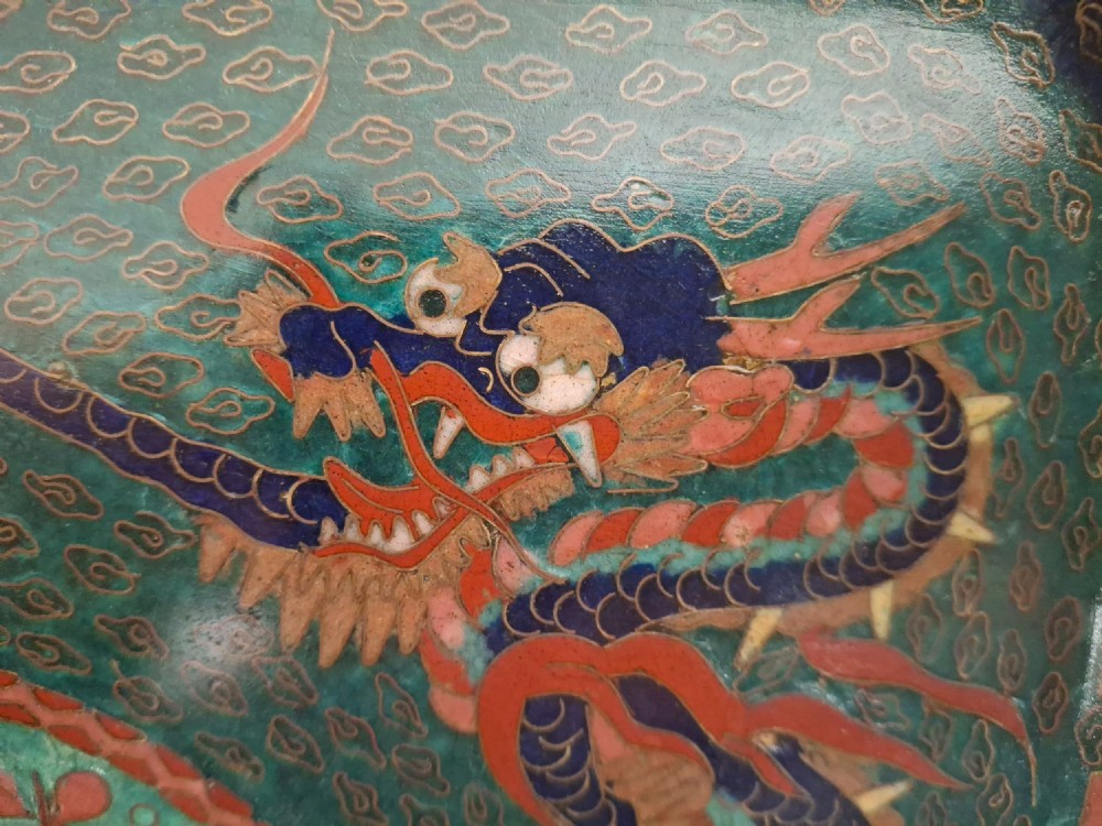 Square Japanese cloisonne enamel tray featuring a central bird motif surrounded by two coiled dragons on a teal patterned ground. View IV