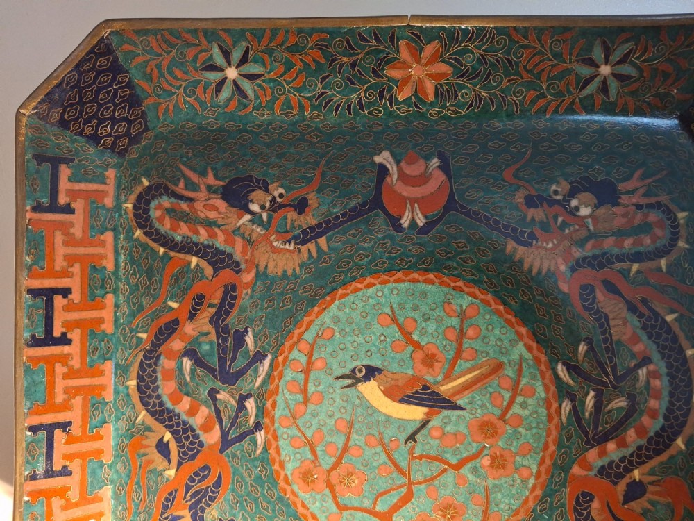 Square Japanese cloisonne enamel tray featuring a central bird motif surrounded by two coiled dragons on a teal patterned ground. View V