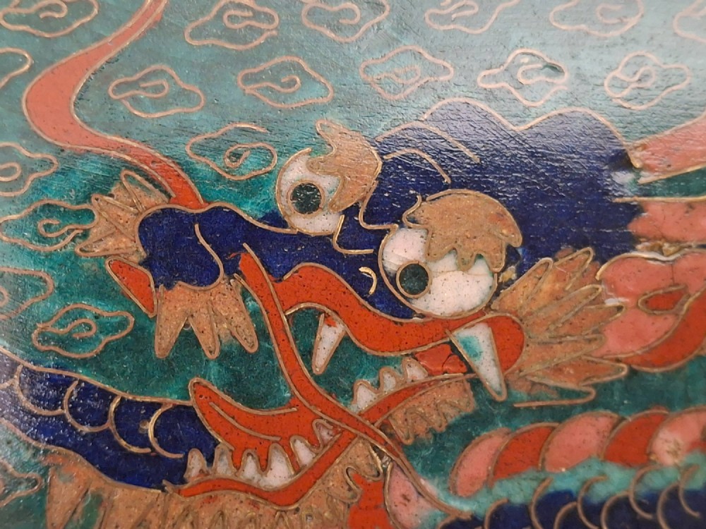 Square Japanese cloisonne enamel tray featuring a central bird motif surrounded by two coiled dragons on a teal patterned ground. View X