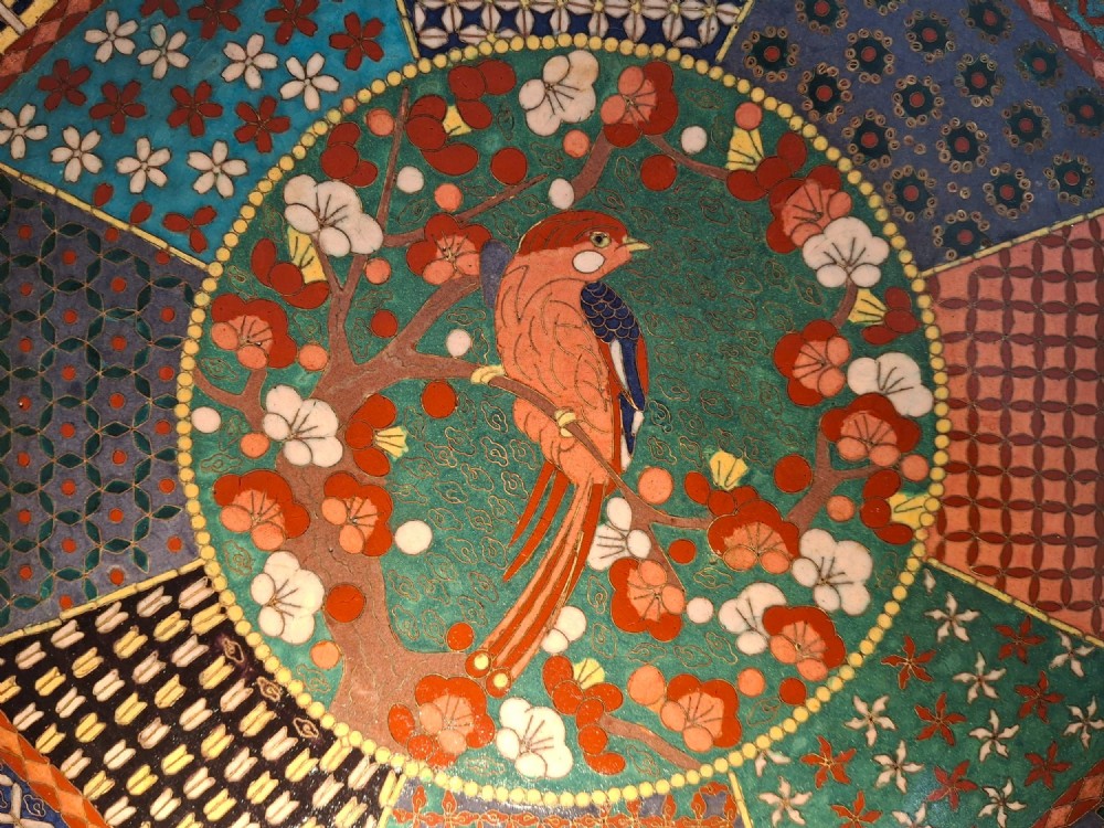 An octagonal antique Japanese cloisonne enamel tray featuring a central bird on a flowering branch surrounded by colourful geometric brocade panels. View II
