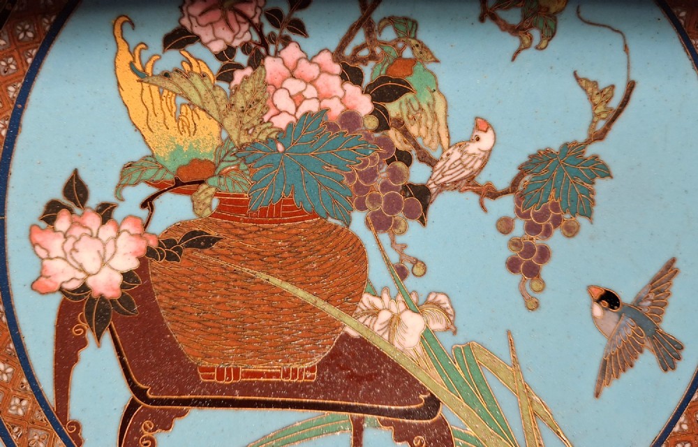 A circular Japanese cloisonne enamel charger featuring a central turquoise medallion with a floral vase and birds, enclosed by patterned borders and surrounding nature panels. View III