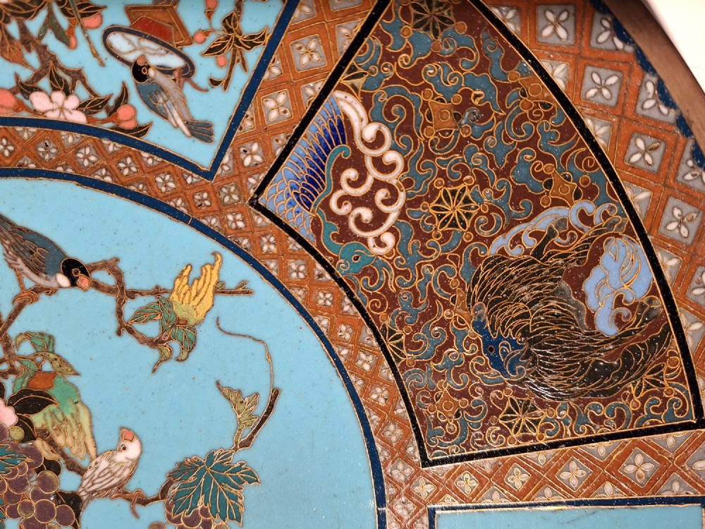 A circular Japanese cloisonne enamel charger featuring a central turquoise medallion with a floral vase and birds, enclosed by patterned borders and surrounding nature panels. View IV