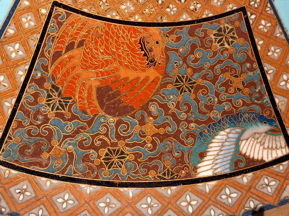 A circular Japanese cloisonne enamel charger featuring a central turquoise medallion with a floral vase and birds, enclosed by patterned borders and surrounding nature panels. View V