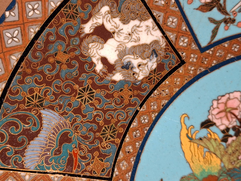 A circular Japanese cloisonne enamel charger featuring a central turquoise medallion with a floral vase and birds, enclosed by patterned borders and surrounding nature panels. View IX