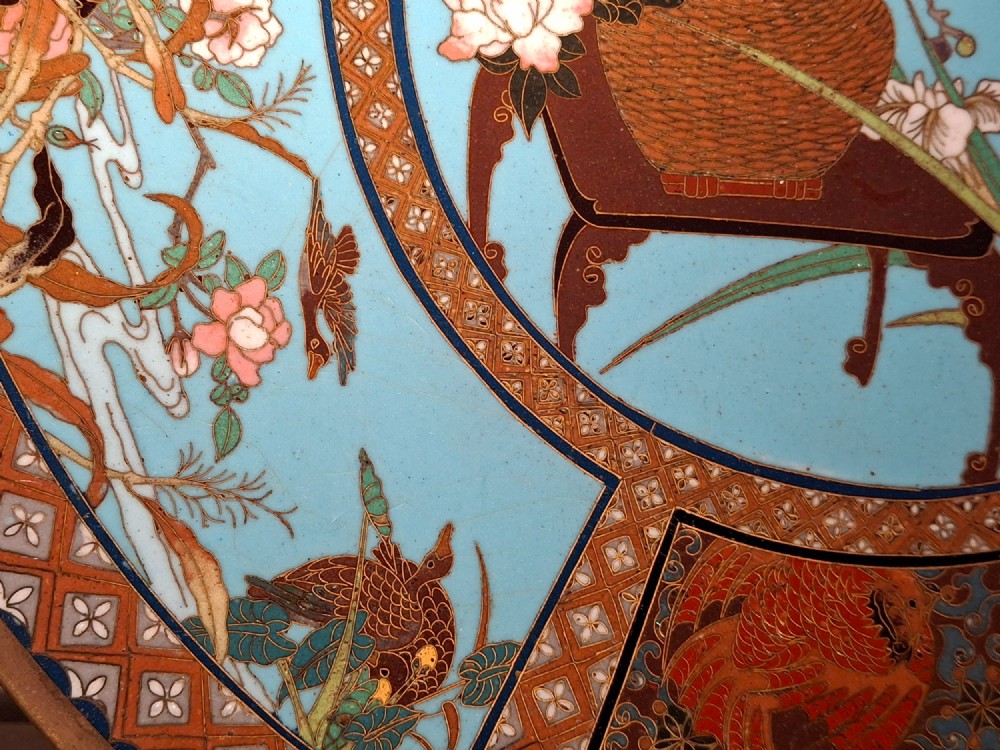 A circular Japanese cloisonne enamel charger featuring a central turquoise medallion with a floral vase and birds, enclosed by patterned borders and surrounding nature panels. View X
