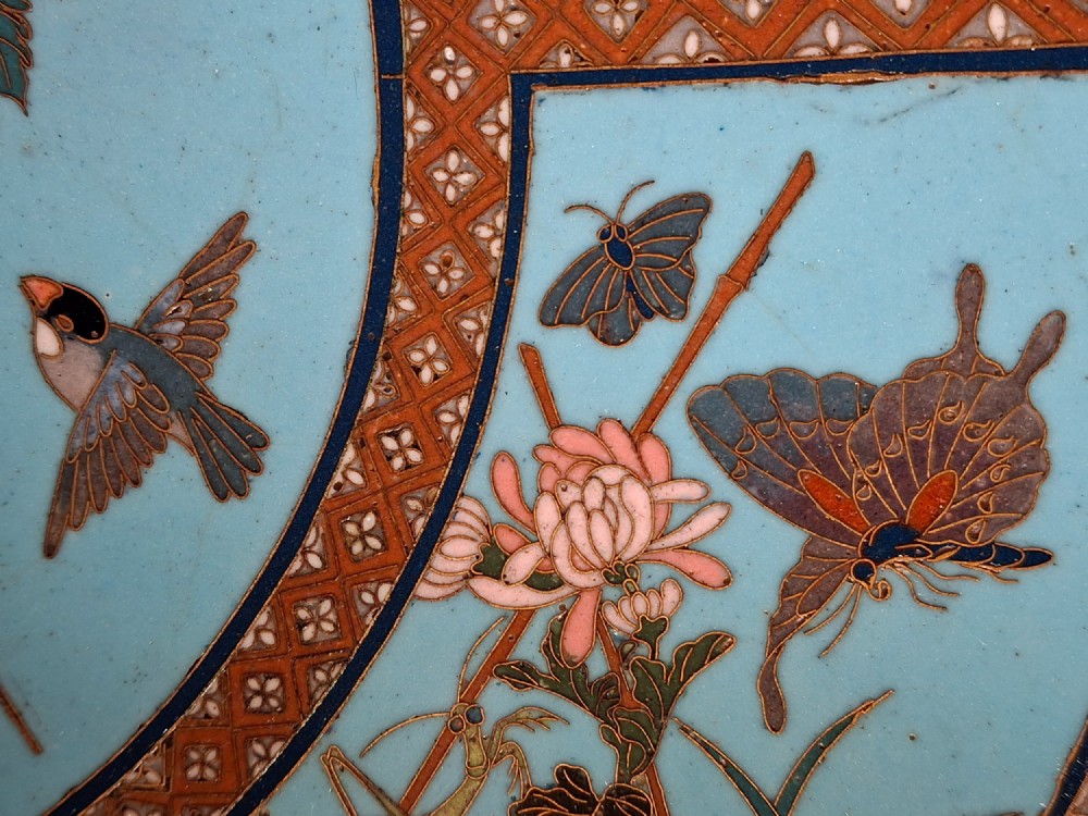 A circular Japanese cloisonne enamel charger featuring a central turquoise medallion with a floral vase and birds, enclosed by patterned borders and surrounding nature panels. View XII