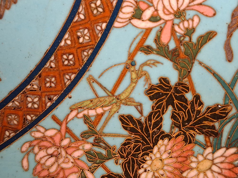 A circular Japanese cloisonne enamel charger featuring a central turquoise medallion with a floral vase and birds, enclosed by patterned borders and surrounding nature panels. View XIII