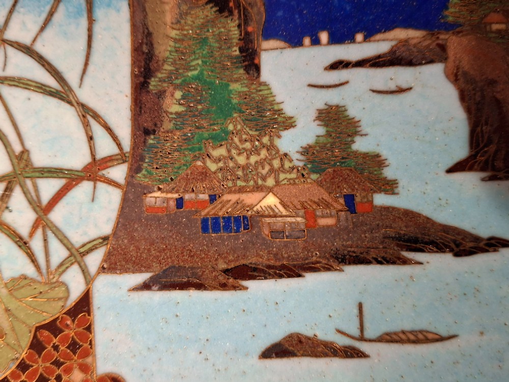 A circular Japanese cloisonne enamel plate featuring geometric patterned borders around asymmetrical panels depicting flora, a bird, and a nocturnal coastal scene. View V