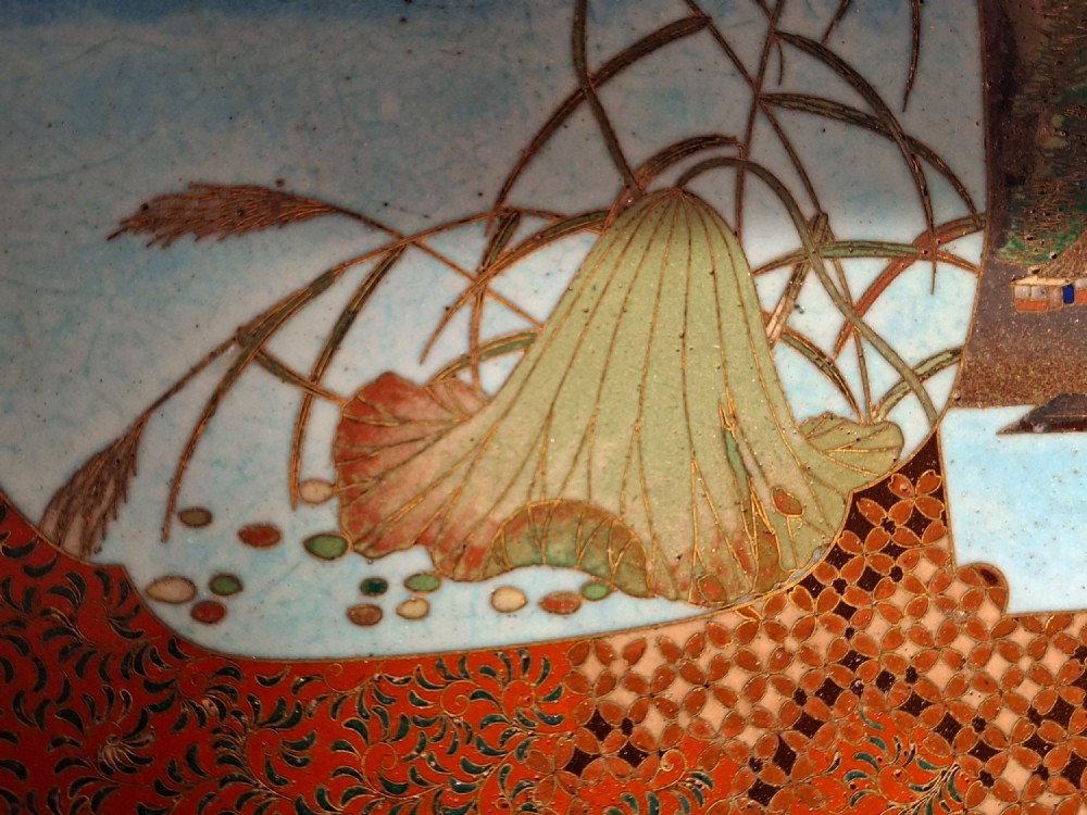 A circular Japanese cloisonne enamel plate featuring geometric patterned borders around asymmetrical panels depicting flora, a bird, and a nocturnal coastal scene. View IX