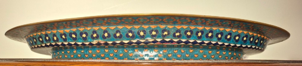 An oval Japanese cloisonne enamel tray featuring a turquoise background decorated with blue and orange iris flowers alongside geometric lattice patterns. View IX