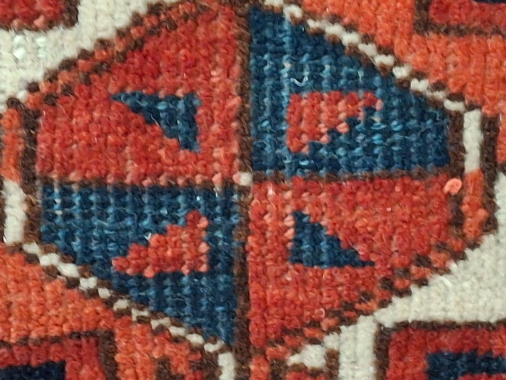 A rectangular antique handwoven wool Ersari Turkoman chuval face featuring fifteen stepped octagonal gul motifs arranged on a deep rust-red field within geometric borders. View VI