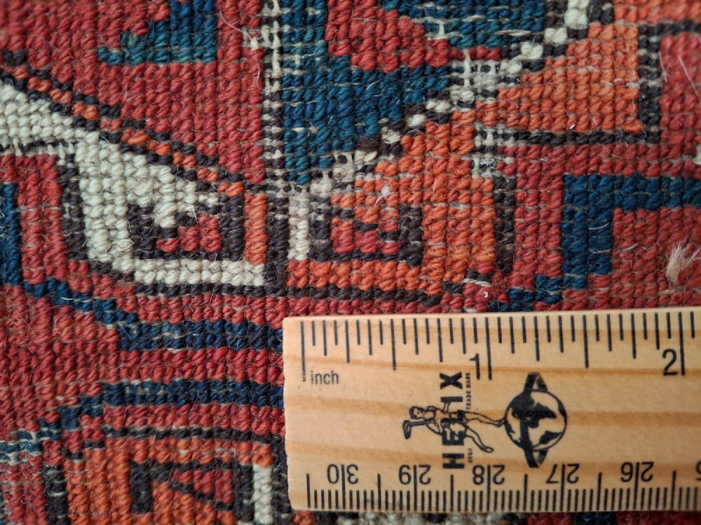 A rectangular antique handwoven wool Ersari Turkoman chuval face featuring fifteen stepped octagonal gul motifs arranged on a deep rust-red field within geometric borders. View XIII
