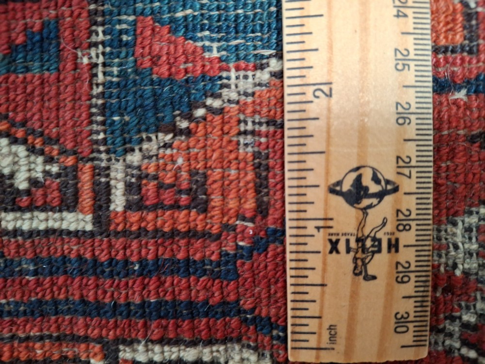 A rectangular antique handwoven wool Ersari Turkoman chuval face featuring fifteen stepped octagonal gul motifs arranged on a deep rust-red field within geometric borders. View XIV
