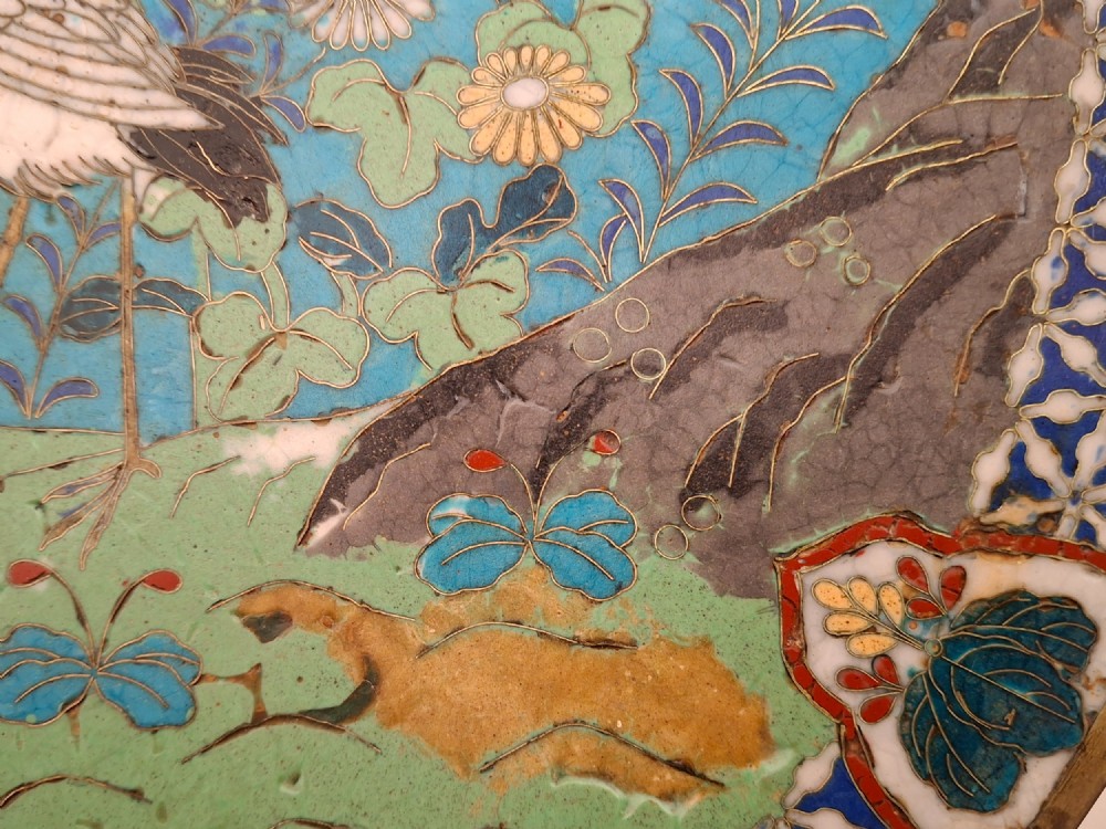 A circular Japanese cloisonne enamel decorative plate decorated with two wading birds surrounded by flowers against a turquoise ground with an ornamental geometric border. View VI
