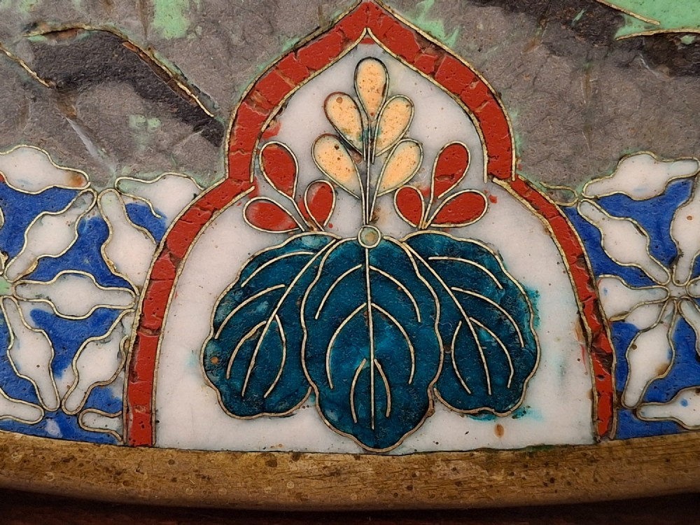 A circular Japanese cloisonne enamel decorative plate decorated with two wading birds surrounded by flowers against a turquoise ground with an ornamental geometric border. View X