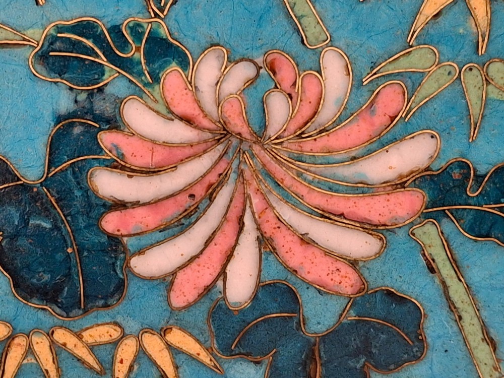 A circular Japanese cloisonne enamel decorative plate decorated with two wading birds surrounded by flowers against a turquoise ground with an ornamental geometric border. View XII