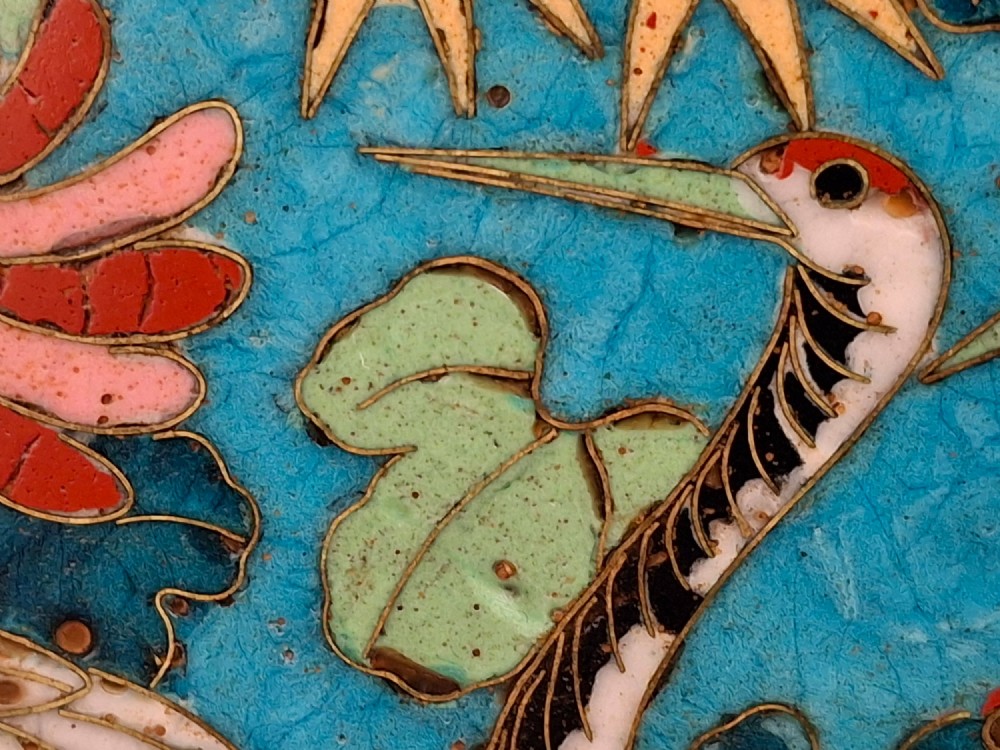 A circular Japanese cloisonne enamel decorative plate decorated with two wading birds surrounded by flowers against a turquoise ground with an ornamental geometric border. View XIII