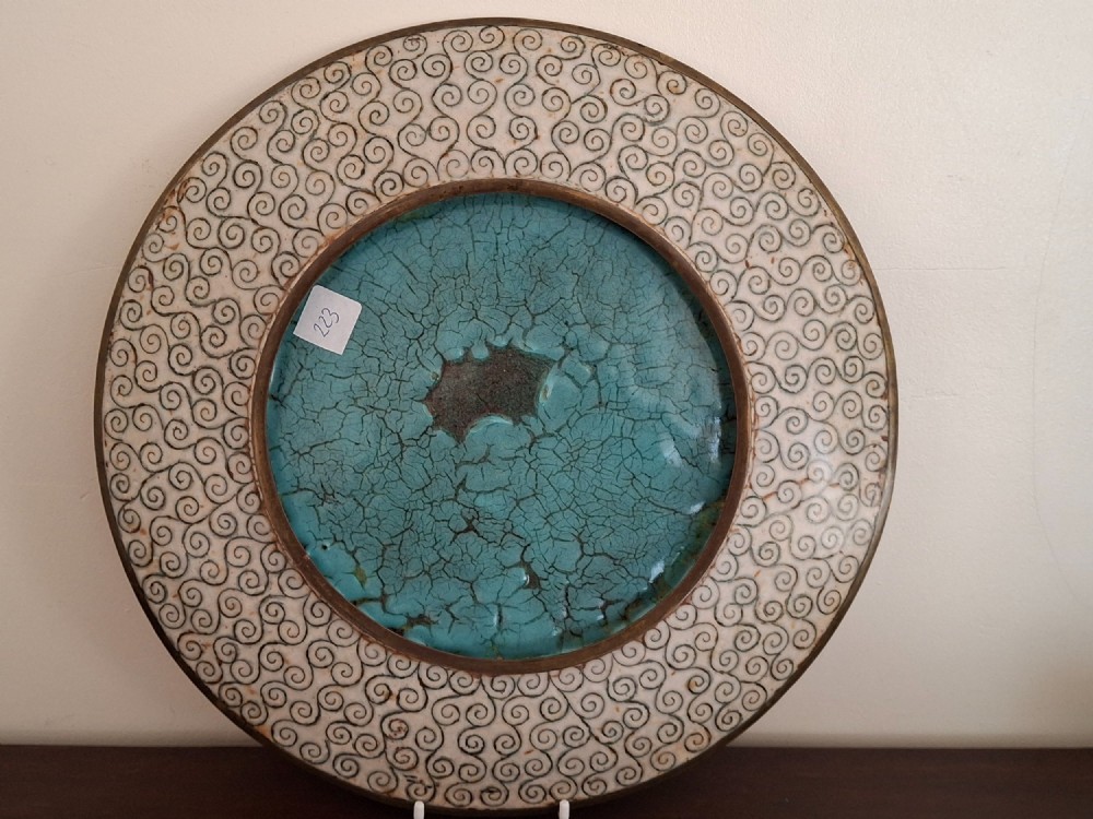 A circular Japanese cloisonne enamel decorative plate decorated with two wading birds surrounded by flowers against a turquoise ground with an ornamental geometric border. View XIV
