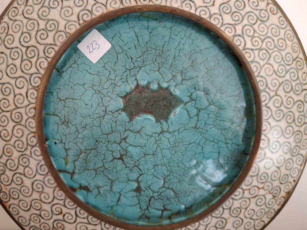 A circular Japanese cloisonne enamel decorative plate decorated with two wading birds surrounded by flowers against a turquoise ground with an ornamental geometric border. View XV