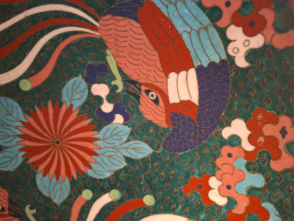 A circular antique Japanese cloisonne enamel charger decorated with two colourful Ho-o phoenix birds and a central floral chrysanthemum motif against a dark teal pattern. View IV