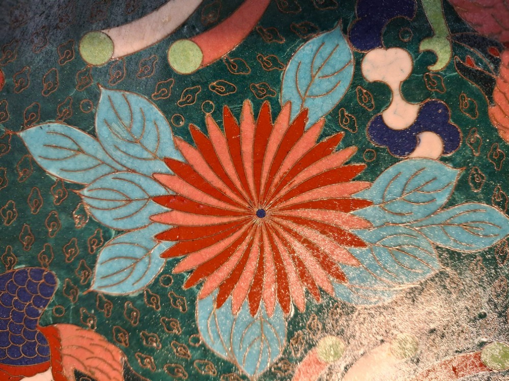 A circular antique Japanese cloisonne enamel charger decorated with two colourful Ho-o phoenix birds and a central floral chrysanthemum motif against a dark teal pattern. View V