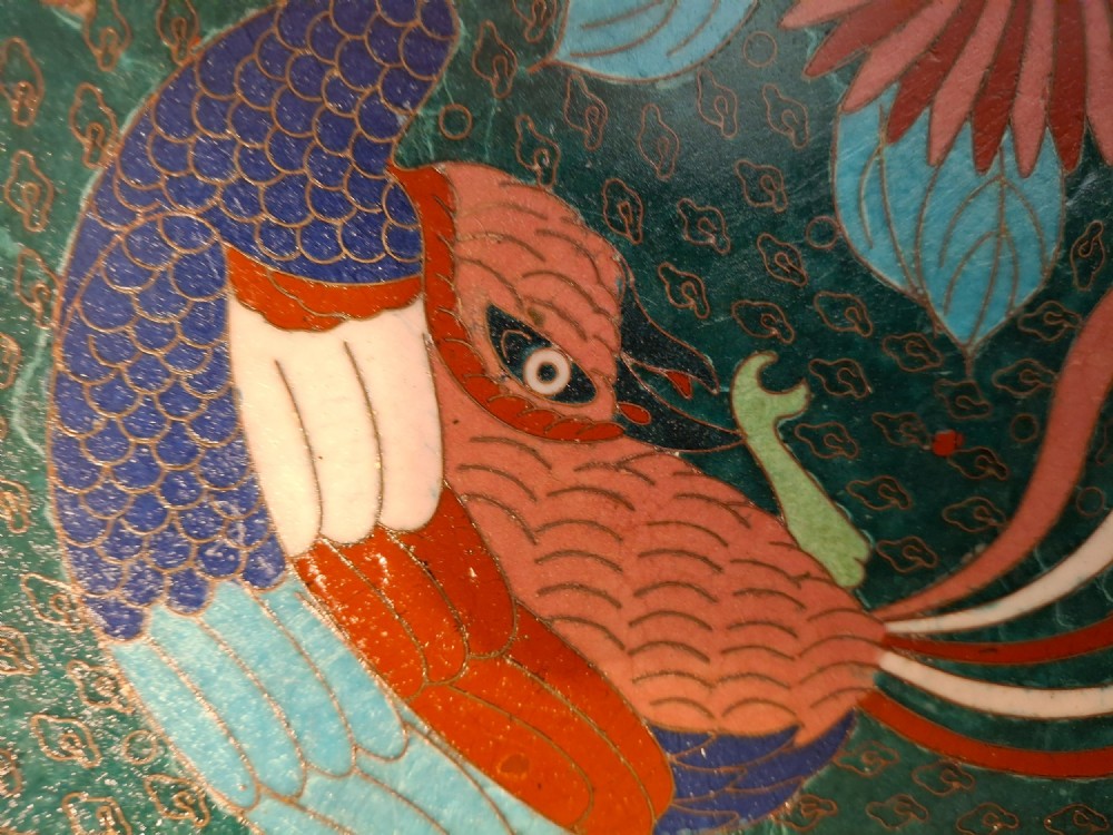 A circular antique Japanese cloisonne enamel charger decorated with two colourful Ho-o phoenix birds and a central floral chrysanthemum motif against a dark teal pattern. View VIII