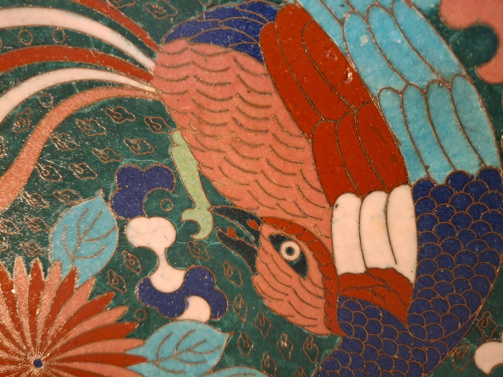 A circular antique Japanese cloisonne enamel charger decorated with two colourful Ho-o phoenix birds and a central floral chrysanthemum motif against a dark teal pattern. View IX