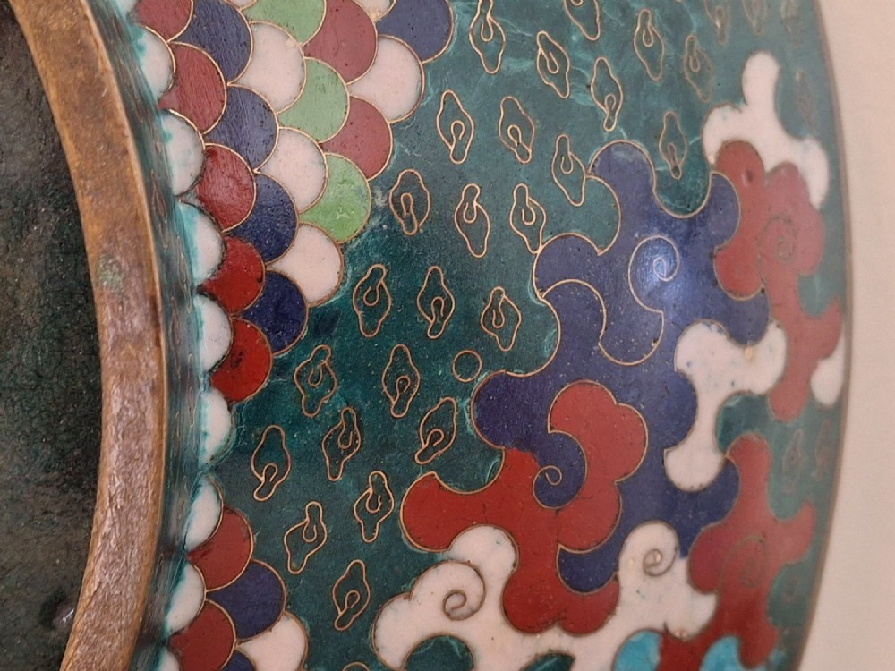 A circular antique Japanese cloisonne enamel charger decorated with two colourful Ho-o phoenix birds and a central floral chrysanthemum motif against a dark teal pattern. View XIV