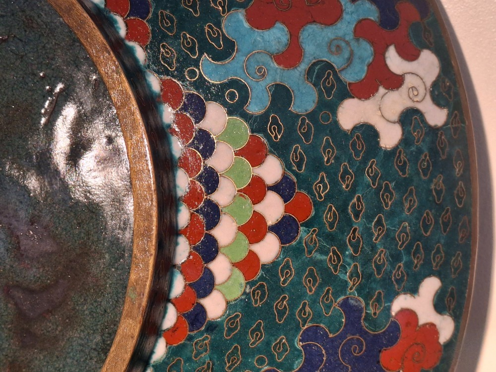 A circular antique Japanese cloisonne enamel charger decorated with two colourful Ho-o phoenix birds and a central floral chrysanthemum motif against a dark teal pattern. View XV