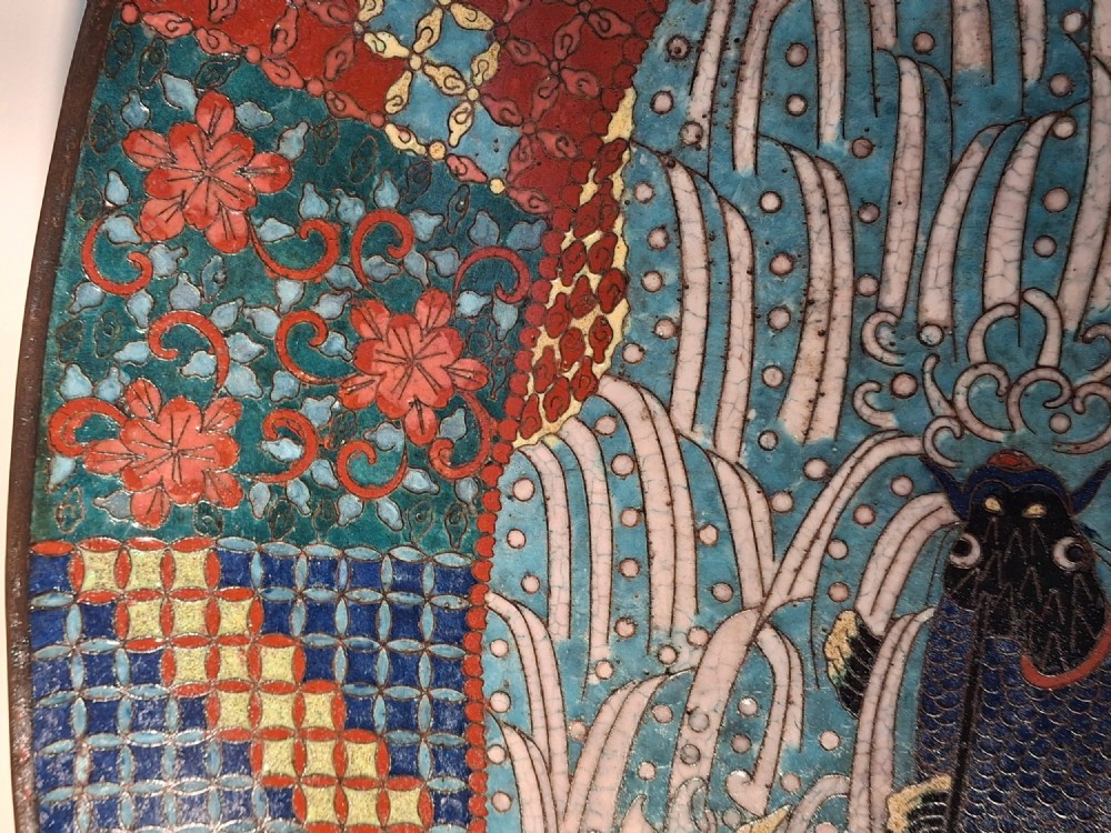 An oval Japanese cloisonne enamel tray displaying a central blue leaping koi carp within stylized waves, surrounded by geometric and red floral patterned borders. View VIII