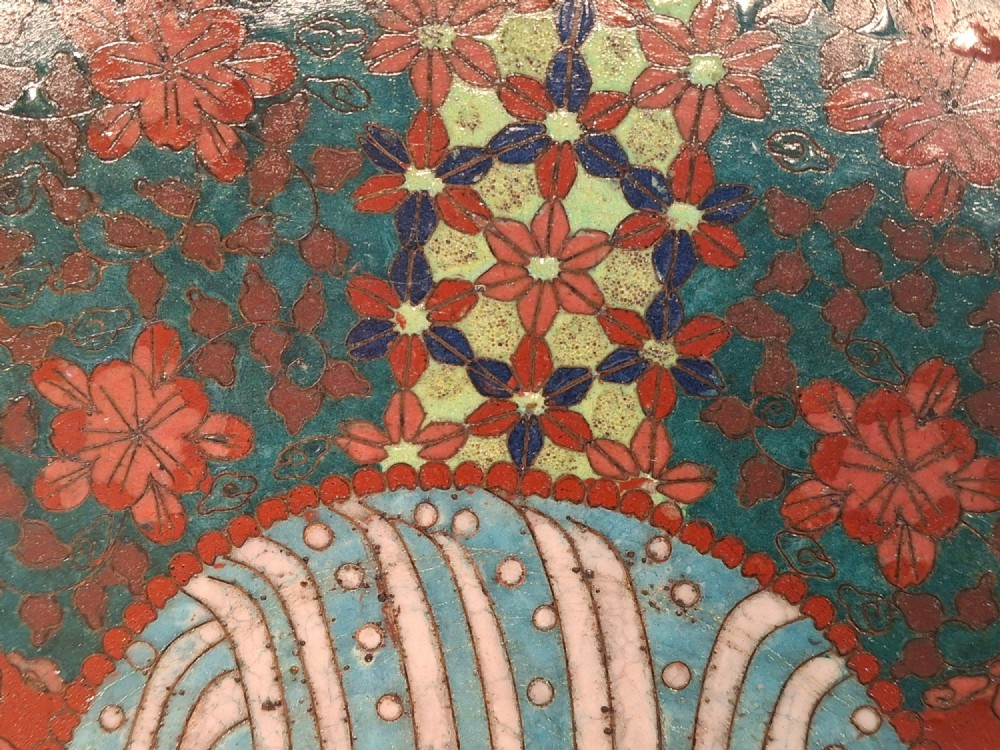 An oval Japanese cloisonne enamel tray displaying a central blue leaping koi carp within stylized waves, surrounded by geometric and red floral patterned borders. View X