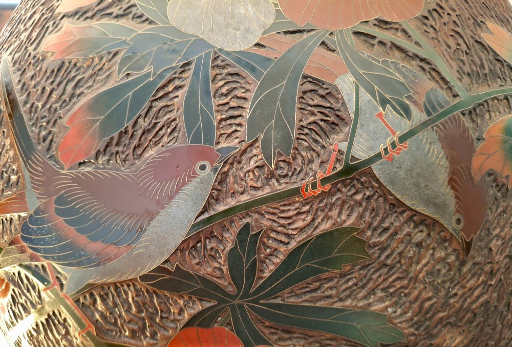 A round antique Japanese Totai Shippo covered box with a textured tree bark enamel surface decorated with red flowers, birds, and brass rim detailing. View IX