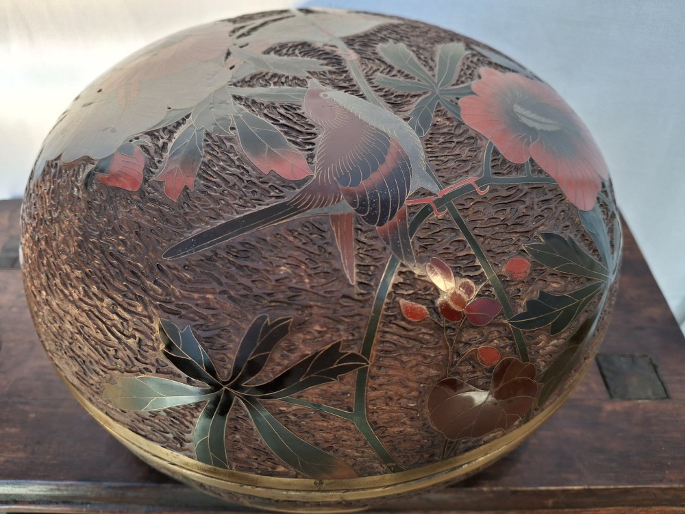A round antique Japanese Totai Shippo covered box with a textured tree bark enamel surface decorated with red flowers, birds, and brass rim detailing. View XI