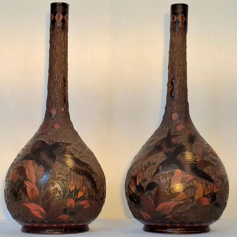 A pair of Japanese Totai Shippo ceramic vases featuring dark brown tree-bark textured surfaces decorated with cloisonne birds and foliage.