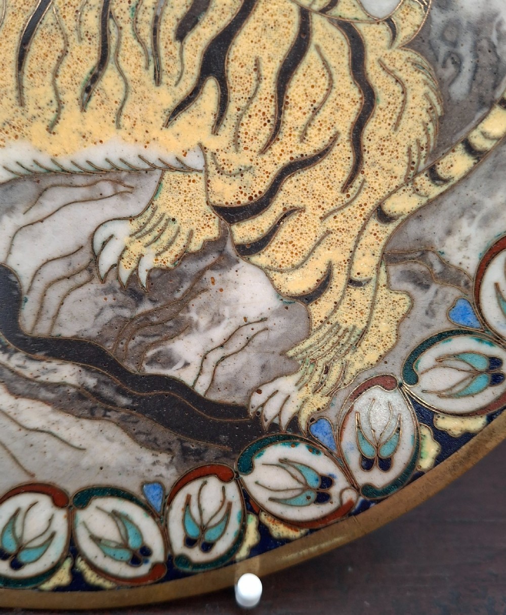 A circular Japanese cloisonne enamel dish depicting a yellow tiger beside bamboo and rocks against a turquoise blue ground with a stylized border. View VII