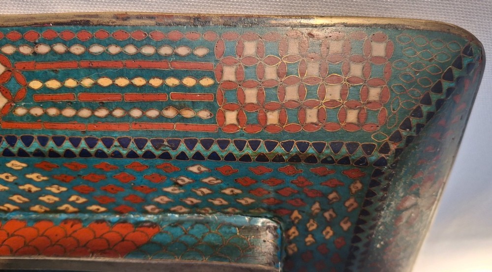 A square Japanese cloisonne enamel tray featuring a central panel with a bird and floral blossoms surrounded by turquoise geometric lattice borders. View XIV