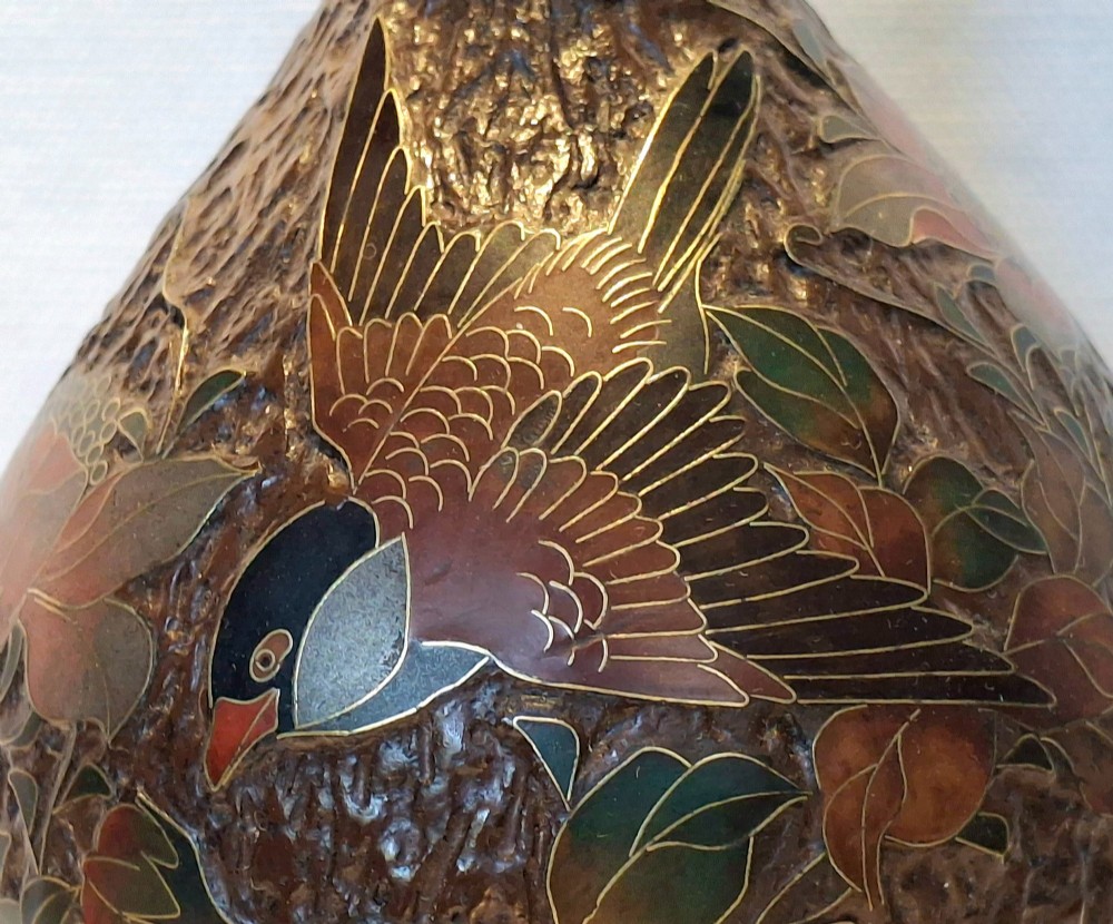 A pear-shaped Japanese Totai Shippo ceramic vase featuring textured brown tree bark enamel with cloisonne bird and floral motifs, resting on a carved dark wood stand. View IX