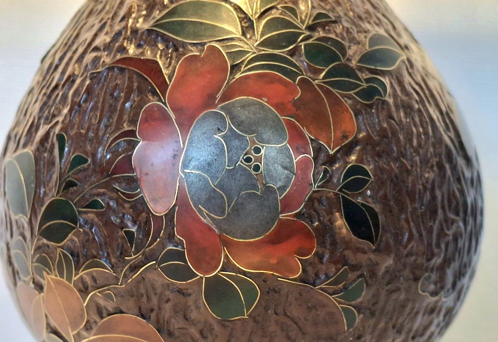 A pear-shaped Japanese Totai Shippo ceramic vase featuring textured brown tree bark enamel with cloisonne bird and floral motifs, resting on a carved dark wood stand. View XIV